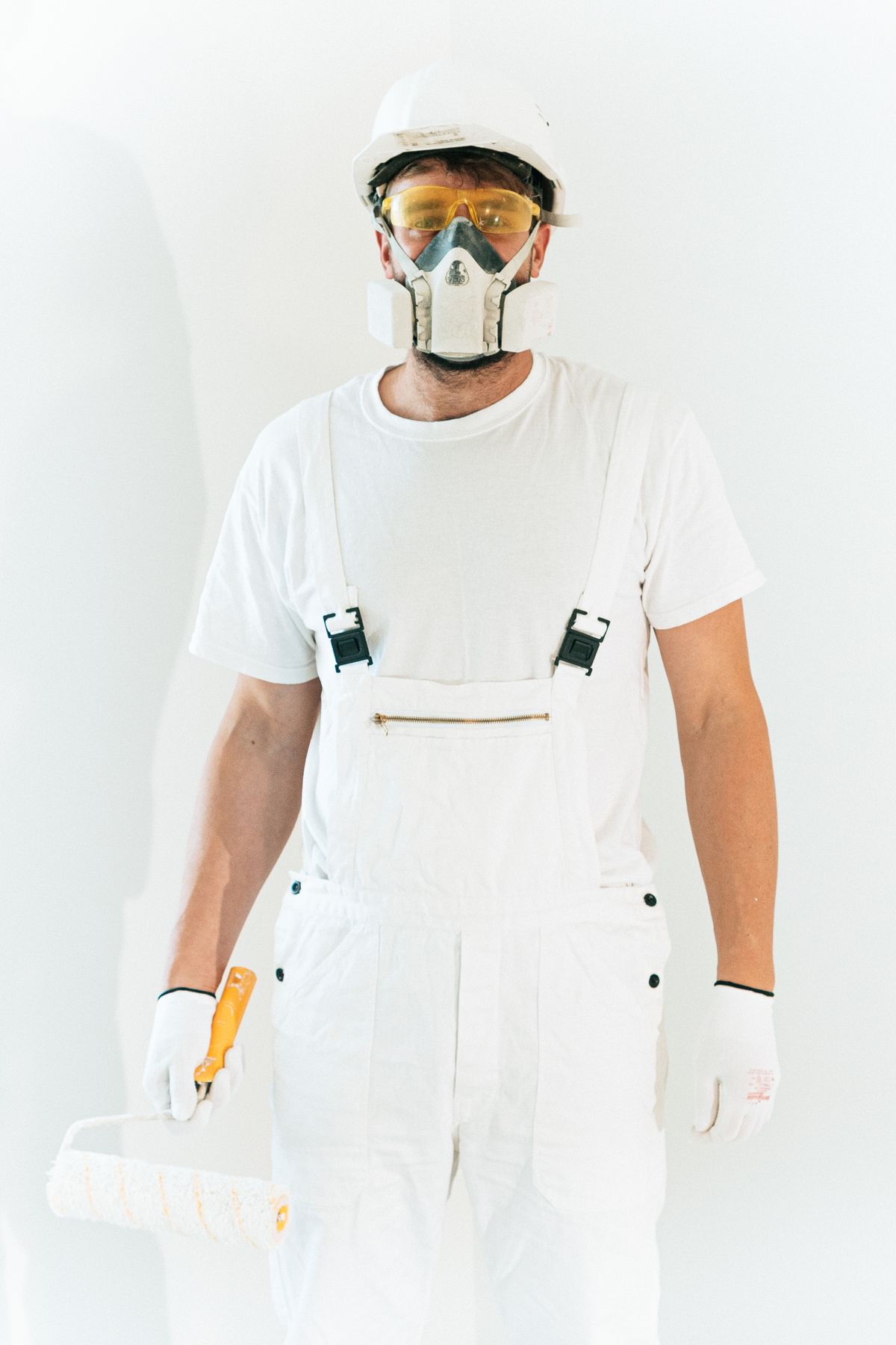 Professional painter with a roller on a job site — placeholder, replace with a photo of Ivan and the crew