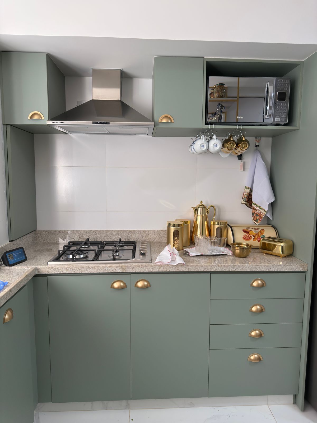 Close-up of refinished kitchen cabinet door with smooth satin topcoat and new hardware