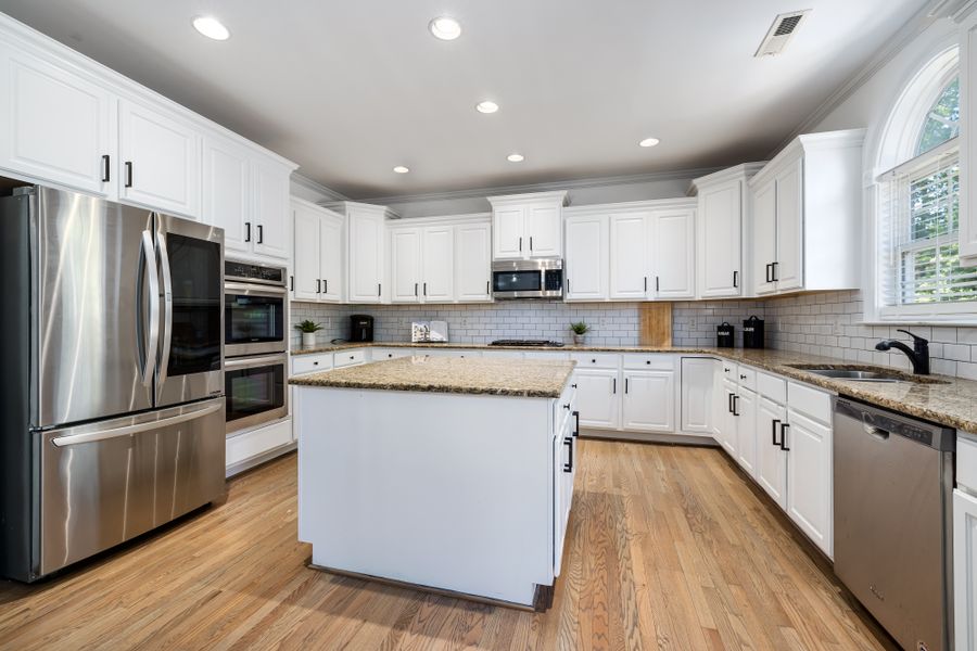 Bright kitchen with freshly finished white cabinets and a center island